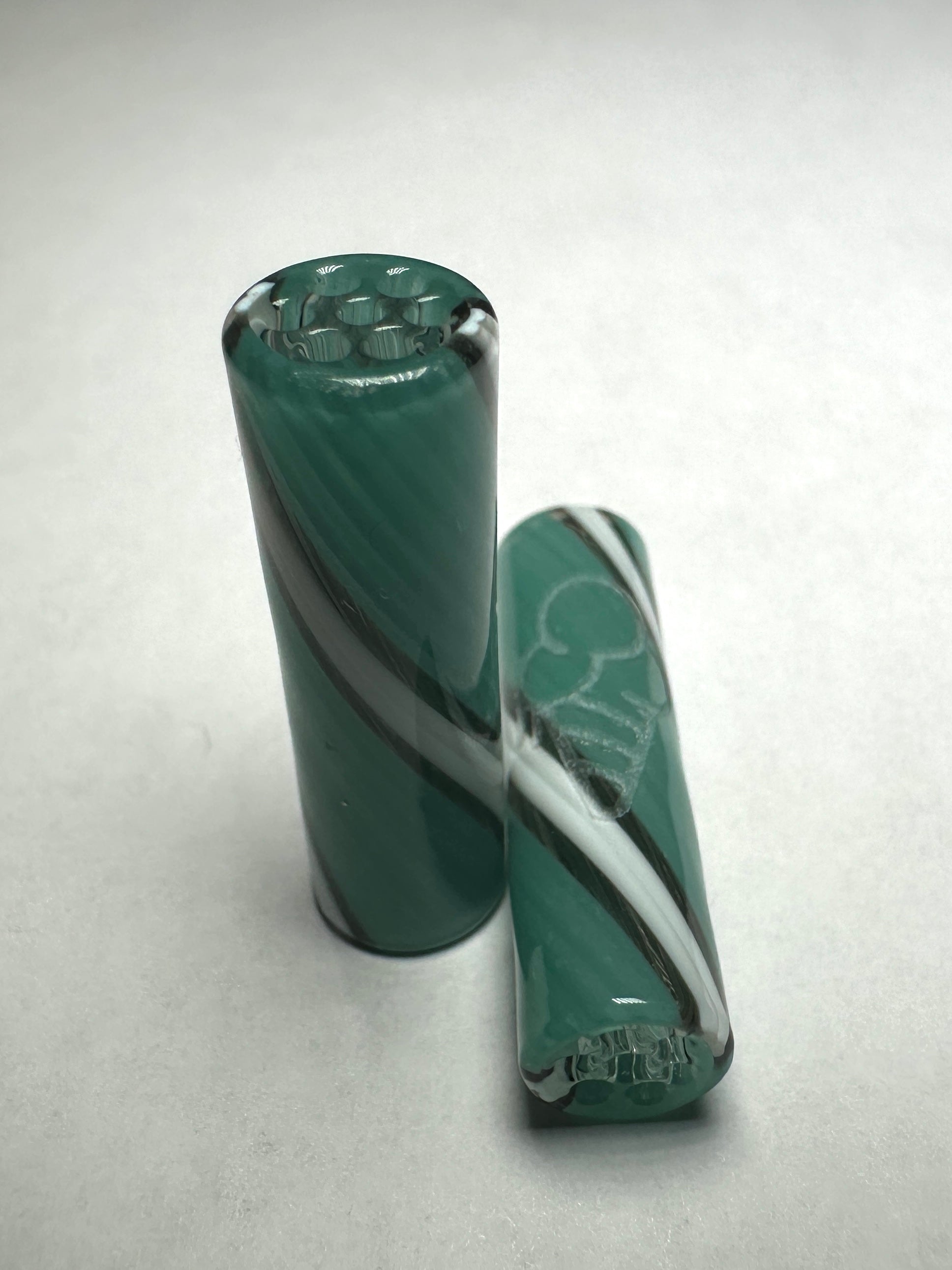 Two Aqua-swirl 8mm straight cylindrical glass rods by CONEZ feature teal and white swirls on a light gray background; one rod stands upright while the other lies horizontally, highlighting intricate internal aqua-swirl designs.
